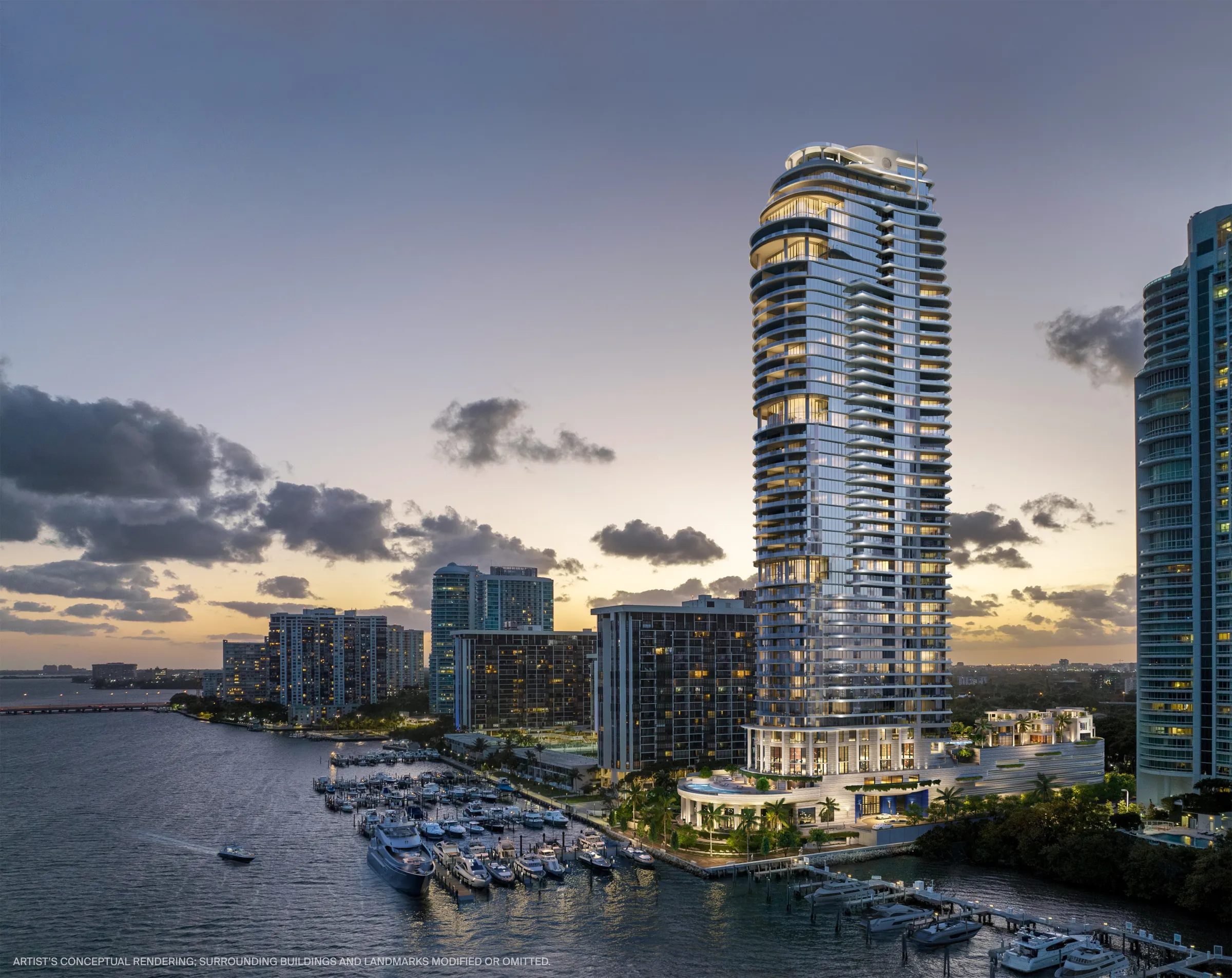 A waterfront Miami residential tower at dusk beside its marina